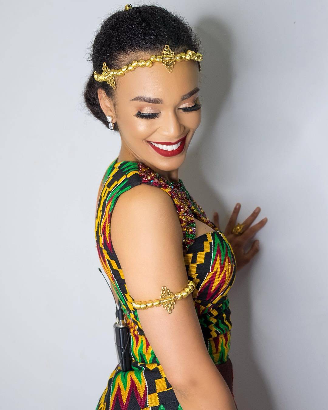 Pearl Thusi in Kente dress and beaded accessories